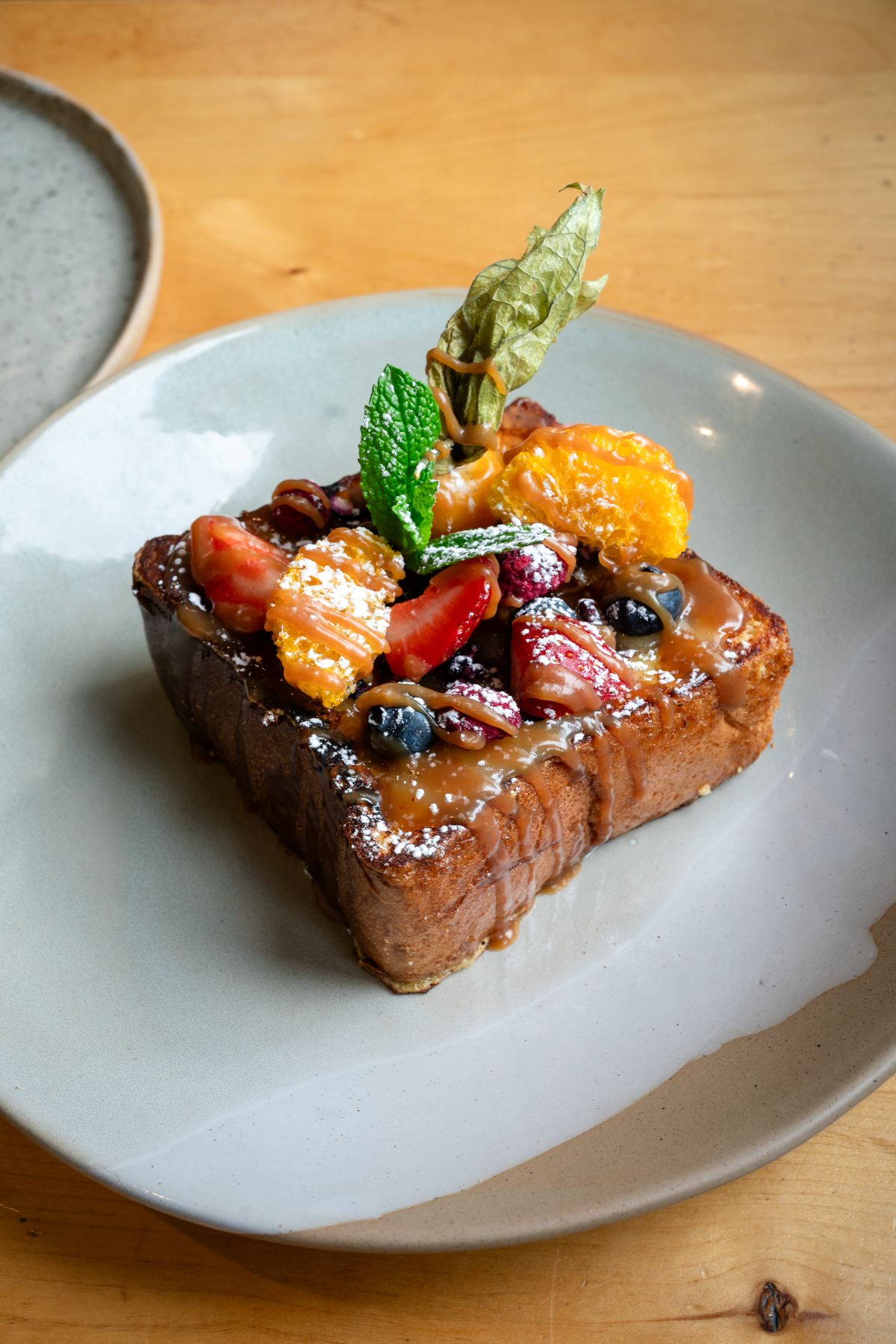Brioche Crème Brûlée French Toast with fresh berries and miso caramel at Alpha Bistro in Banff.