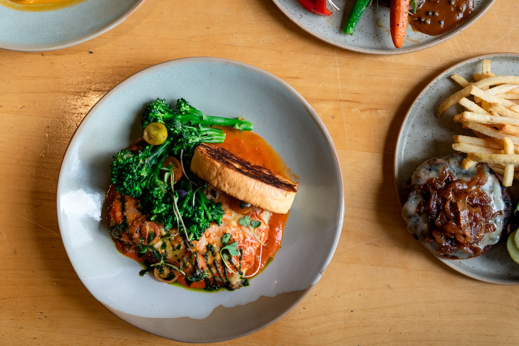Gluten-free miso salmon entree served al fresco on the dining patio at Alpha Bistro in Banff.