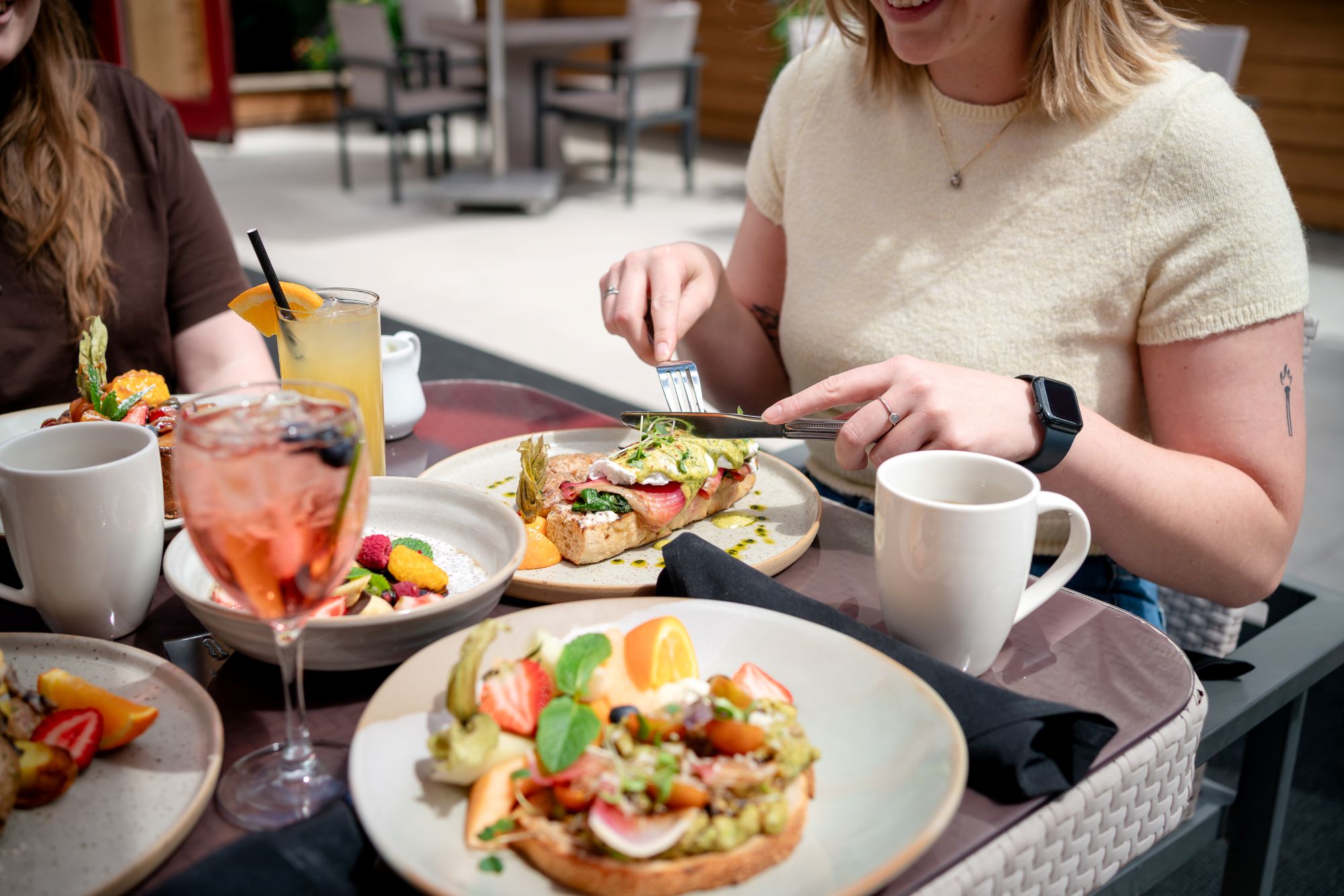 A bright resort breakfast scene inside the Alpha Bistro dining room at Banff Rocky Mountain Resort.